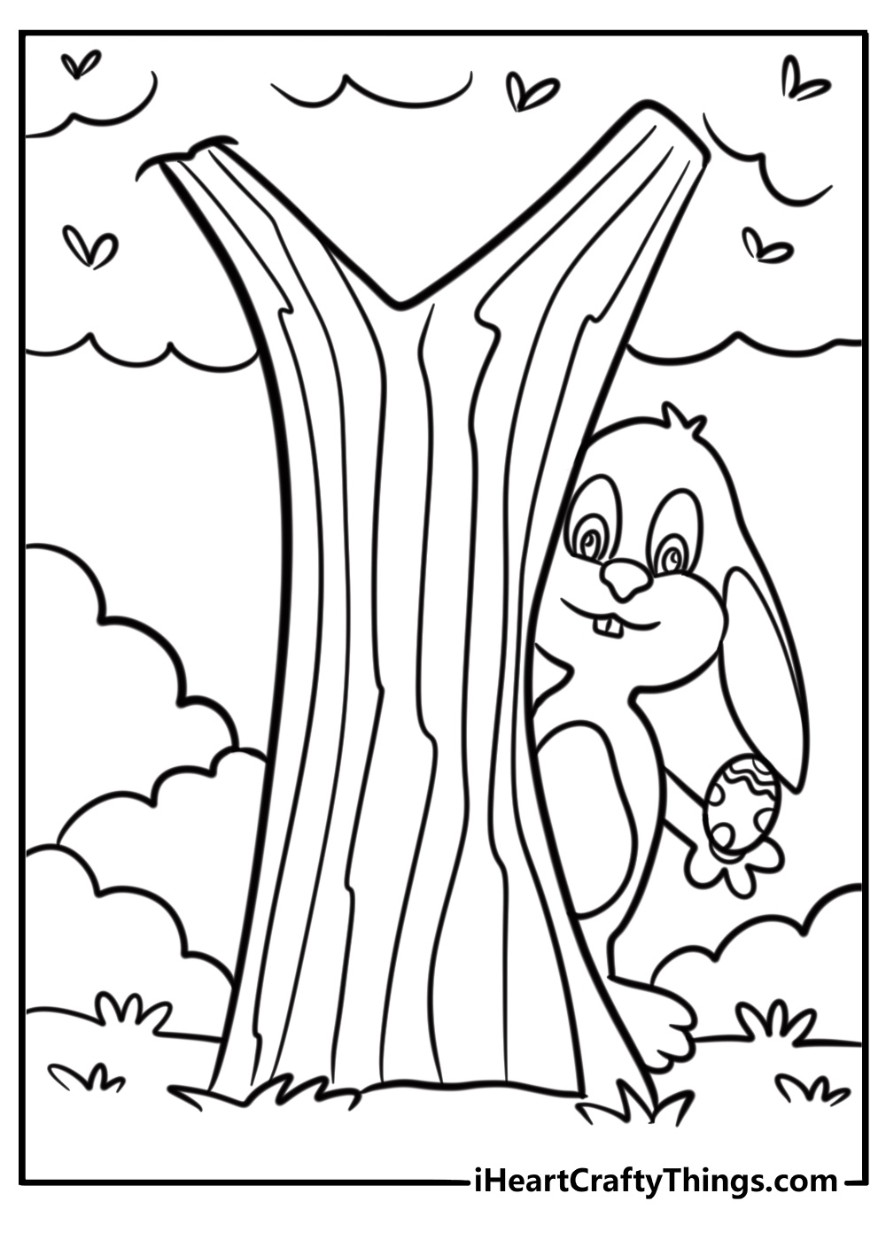 Easter bunny hiding behind a tree with an egg in its paws