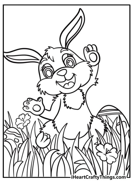 Easter bunny with a big decorated egg in the meadow