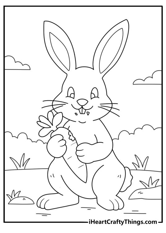 Printable coloring page featuring happy rabbit holding a carrot with a few bites already taken out