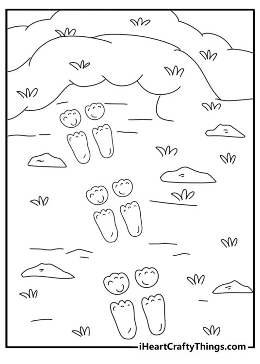 Rabbit tracks leading to a burrow entrance on a hillside printable coloring page