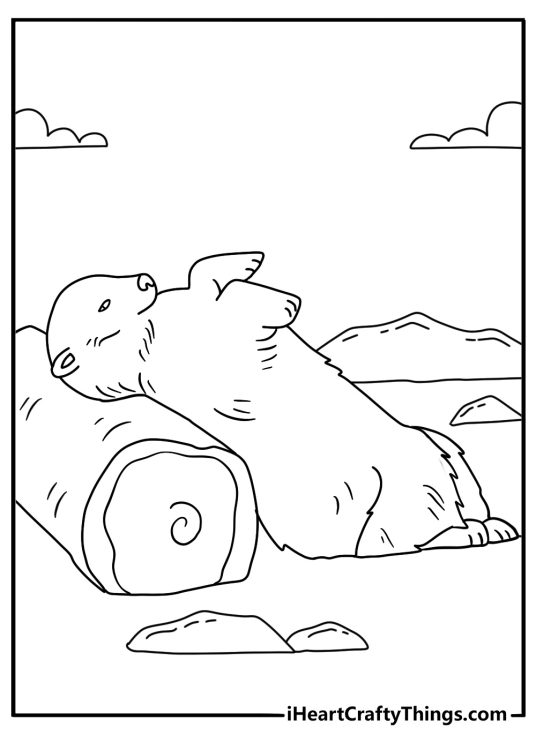 polar bear scratches its back against a large piece of driftwood