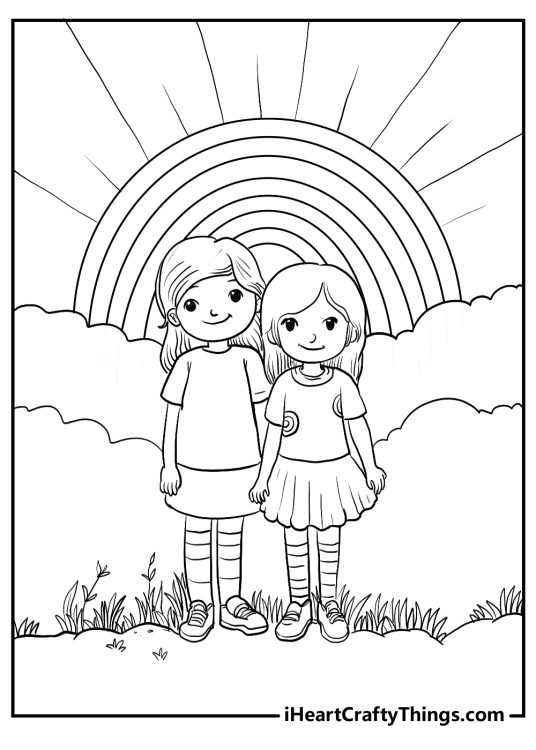 Picture of an outdoors scene with two smiling girls standing surrounded by grass and a rainbow above them