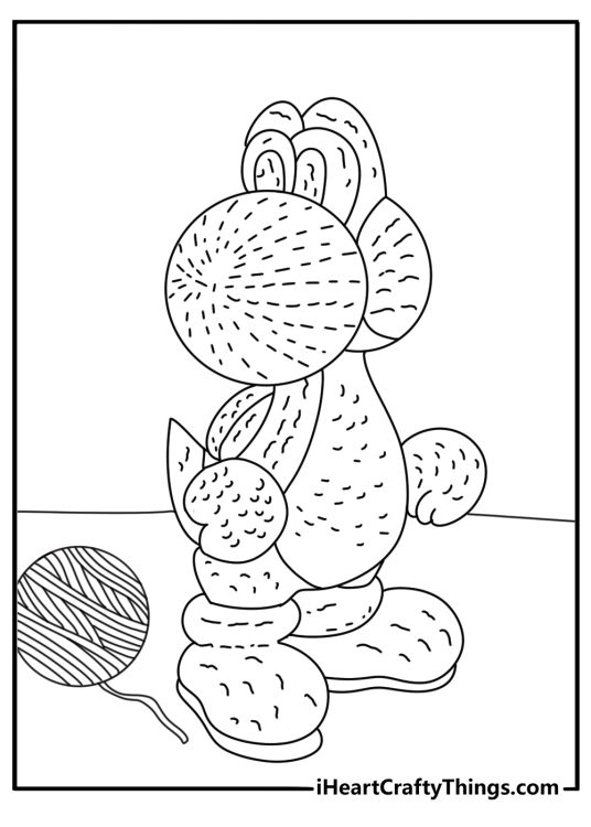 A yarn Yoshi rests near buttons and thread in this cute printable