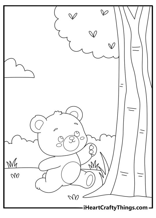 Black and white picture for pre schoolers featuring baby bear playing on a tree with greenery in the background
