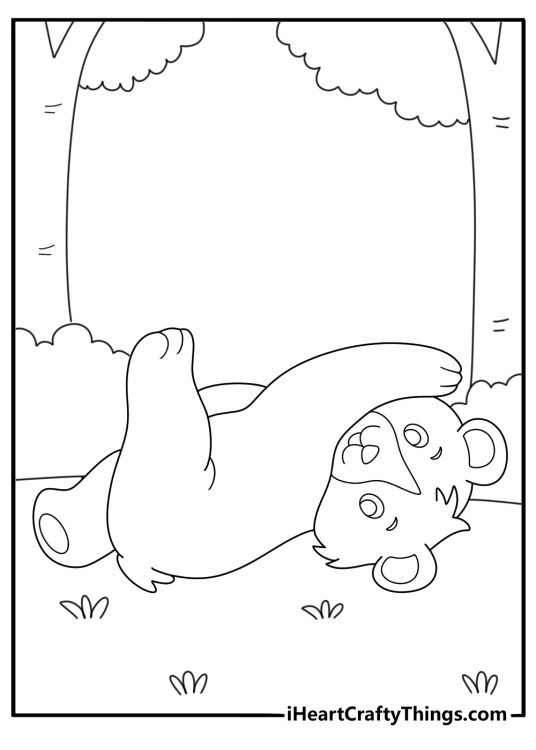 Coloring sheet for children of an adorable little bear cub playing with his feet