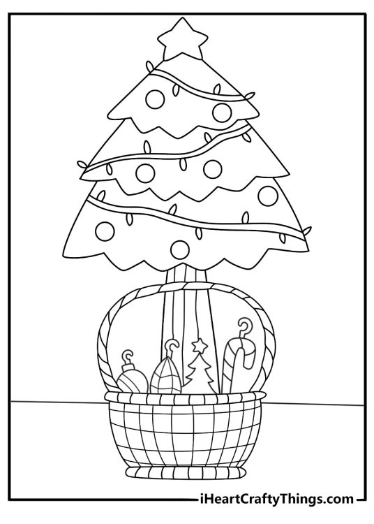 A basket of unused ornaments sits beside the tree in this holiday printable