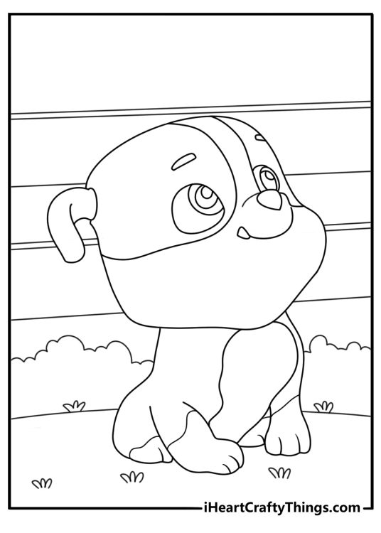 Printable coloring page for pre schoolers of a happy baby Rubble from Paw Patrol sitting on the grass