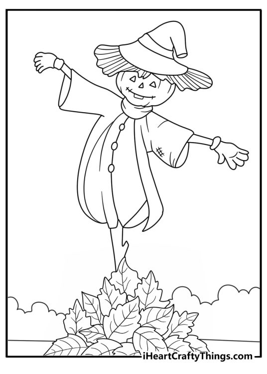 Free printable fall sheet with a scarecrow near a pile of fallen leaves