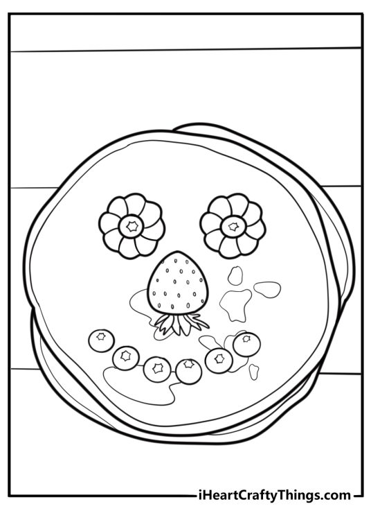 Pancake with a smiley face made of fruit coloring sheet