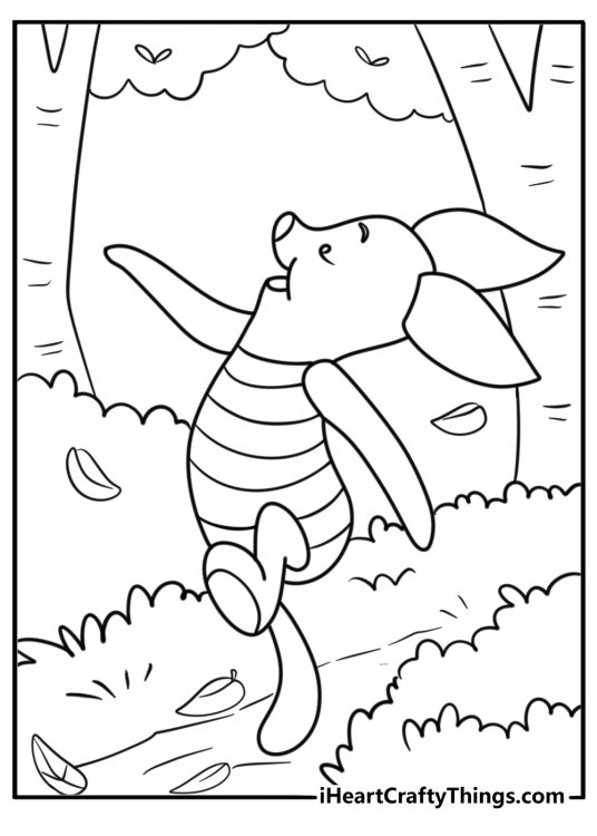 Piglet walking through a forest path with leaves on the ground