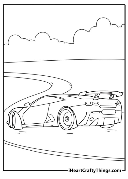 Image of a car with a spoiler on the back driving across the open road under a cloudy sky